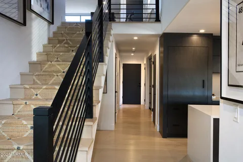 a view of a hallway with paintings on the wall