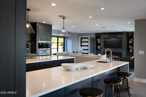 a kitchen with stainless steel appliances a sink and a large window