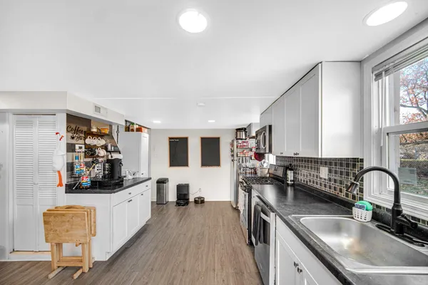 a kitchen with stainless steel appliances granite countertop a sink and stove