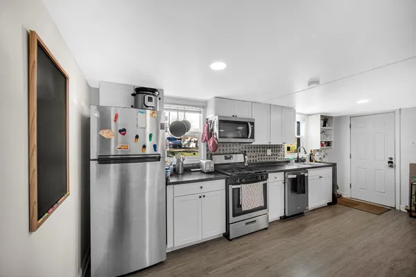 a kitchen with stainless steel appliances a refrigerator stove and sink