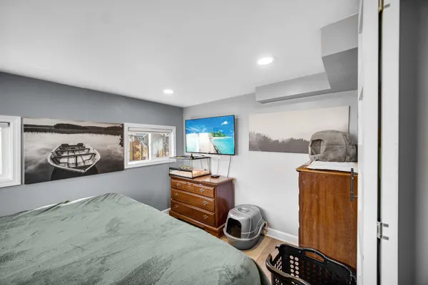 a bedroom with a bed and a dresser in it