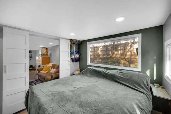 a bed room with a bed and a large window