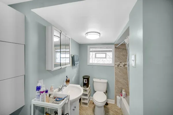a bathroom with a sink toilet and a mirror