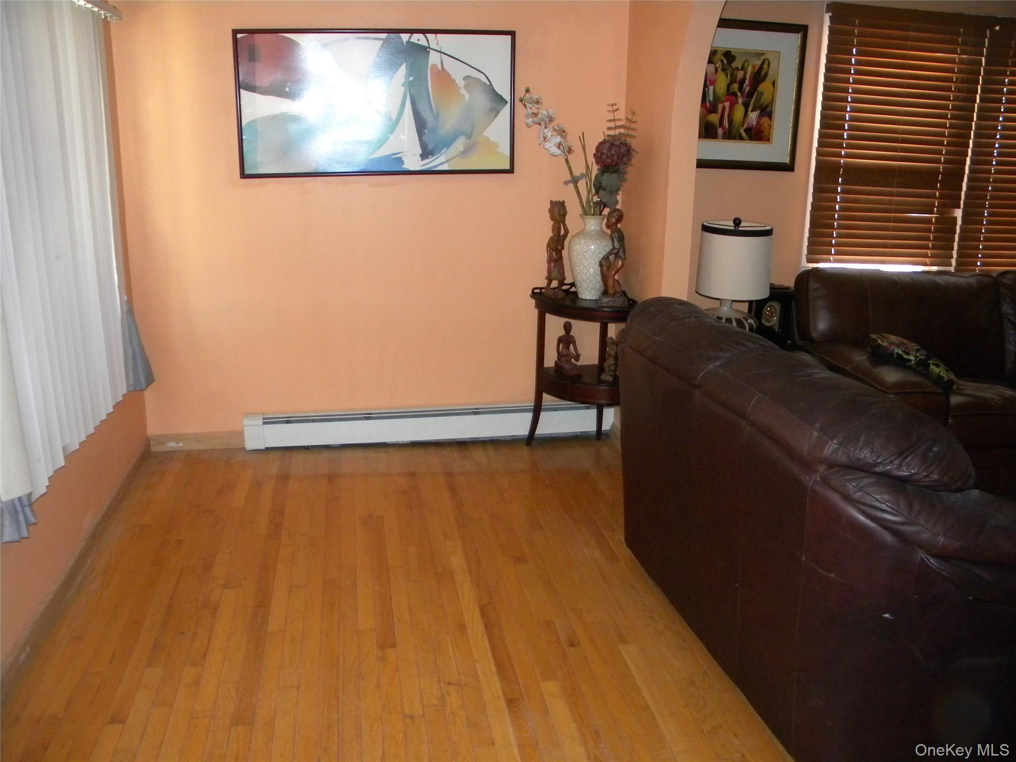 241-26 86th Road Queens, NY 11426 - Photo 4 of 38 a room with wooden floor and furniture