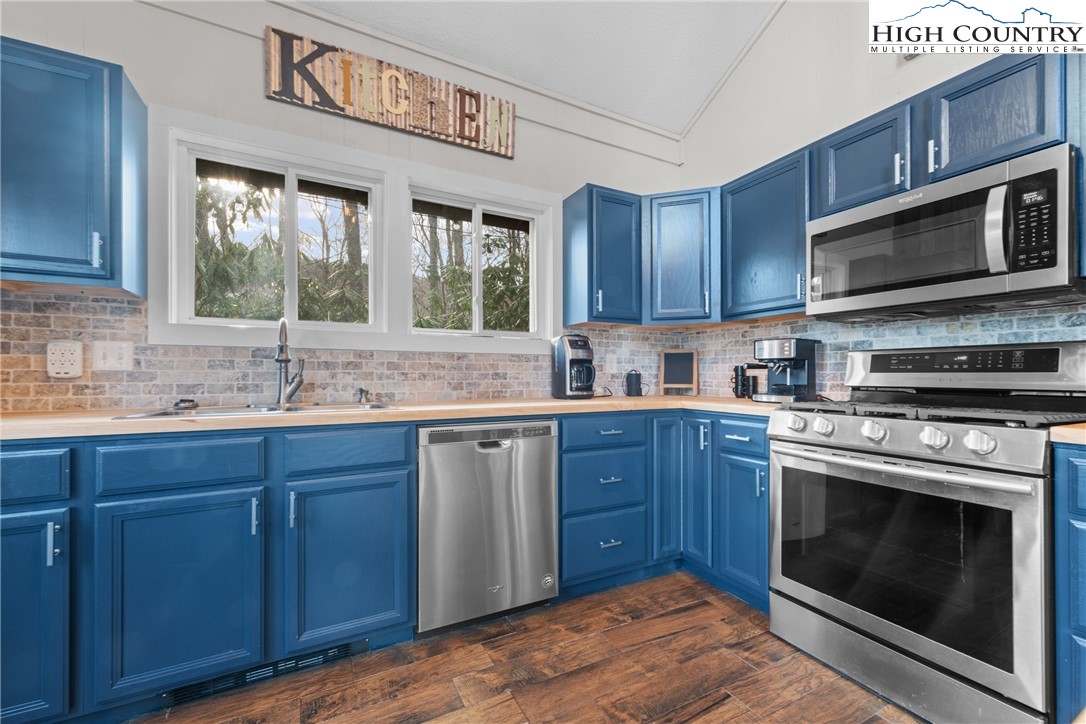 101 Pond Creek Road Banner Elk, NC 28604 - Photo 17 of 35 a kitchen with stainless steel appliances granite countertop a stove sink and microwave