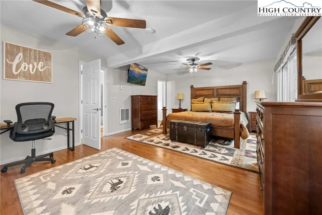 a bedroom with a bed and a large window