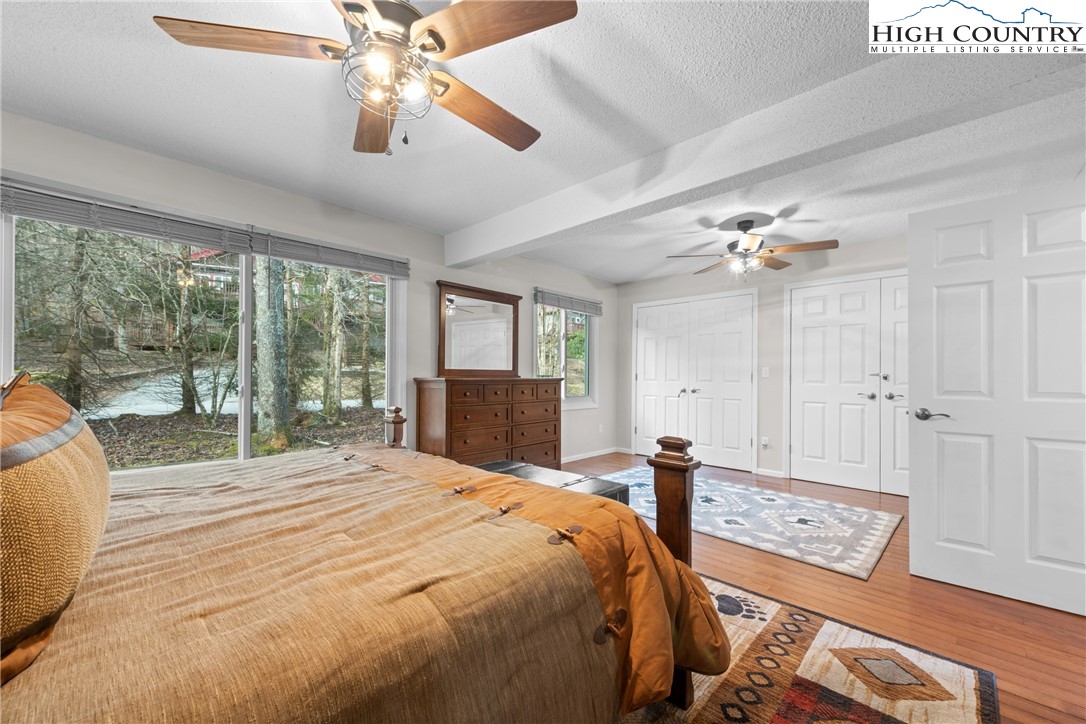 101 Pond Creek Road Banner Elk, NC 28604 - Photo 22 of 35 a bedroom with a bed and a chandelier