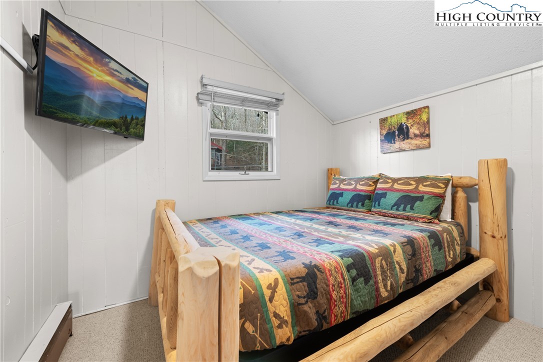 101 Pond Creek Road Banner Elk, NC 28604 - Photo 24 of 35 a bedroom with a bed and a flat screen tv