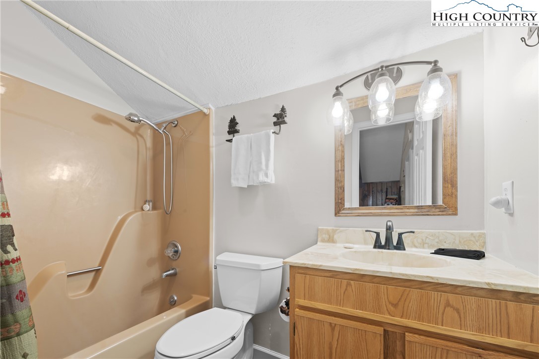 101 Pond Creek Road Banner Elk, NC 28604 - Photo 25 of 35 a bathroom with a sink vanity granite toilet and a mirror