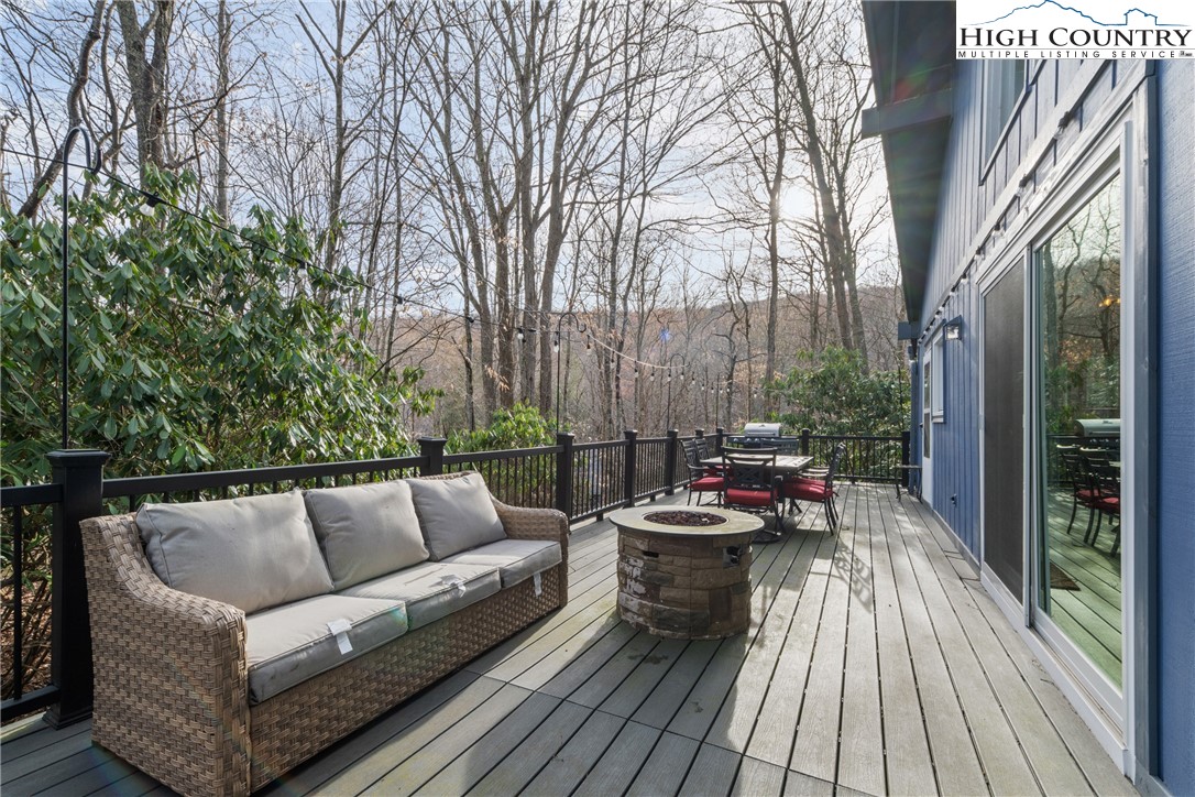 101 Pond Creek Road Banner Elk, NC 28604 - Photo 3 of 35 a view of roof deck with couches and wooden floor