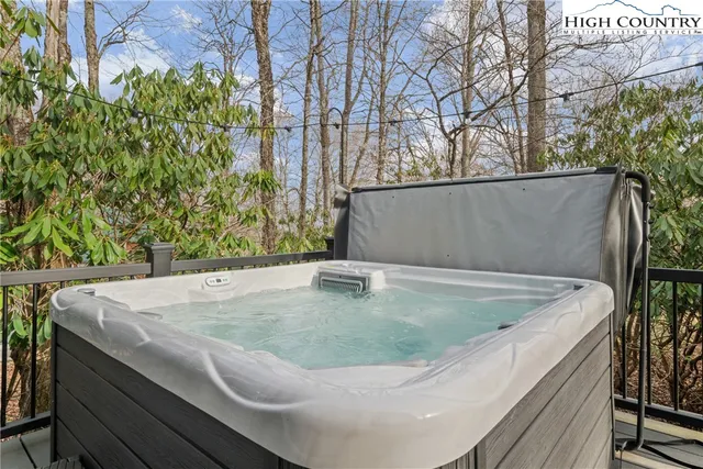 a balcony with wooden floor table and chairs