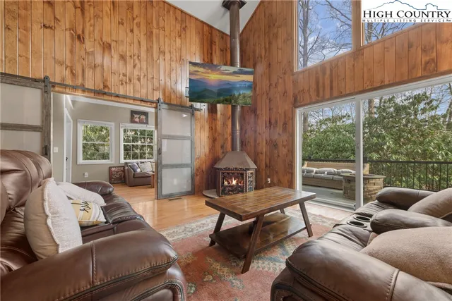 a living room with furniture a large window and a rug
