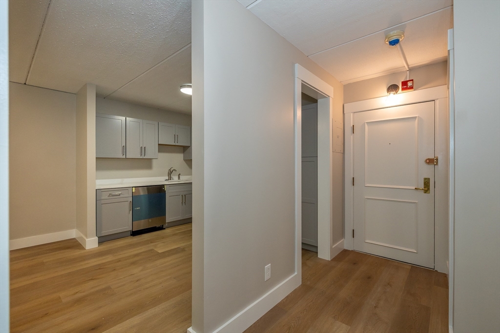 1500 Worcester Road, Unit 217 Framingham, MA 01702 - Photo 11 of 37 a view of a kitchen with a sink and wooden floor
