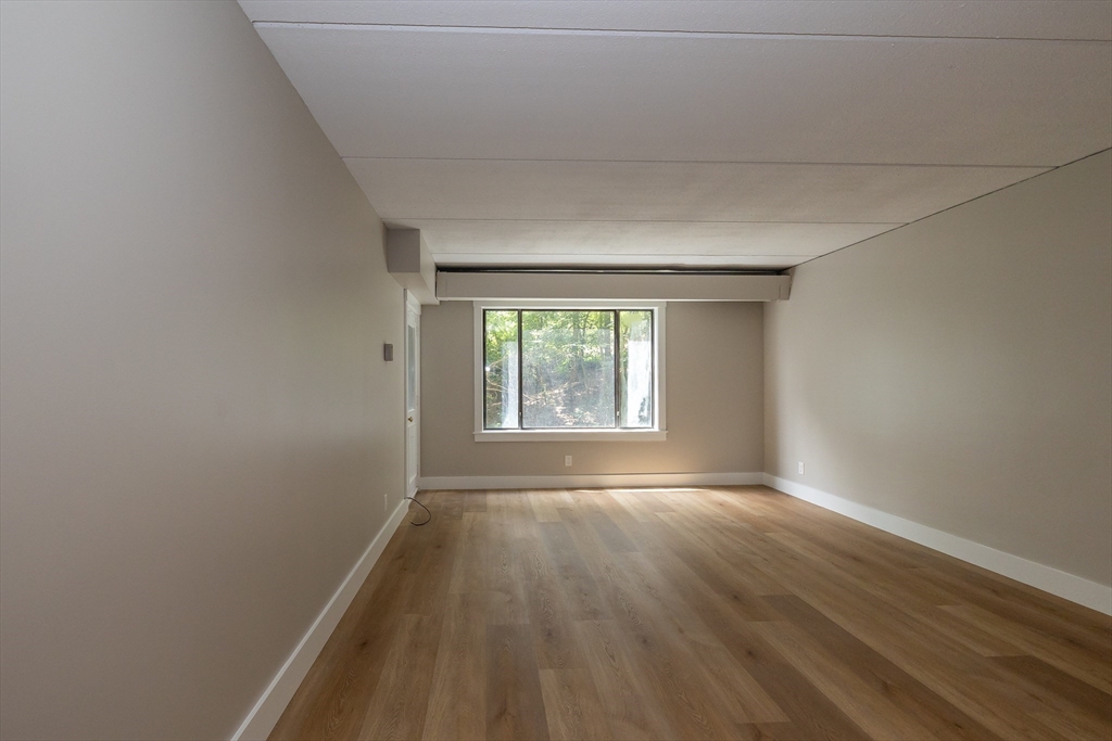 1500 Worcester Road, Unit 217 Framingham, MA 01702 - Photo 16 of 37 wooden floor in an empty room with a window