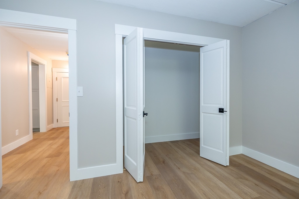 1500 Worcester Road, Unit 217 Framingham, MA 01702 - Photo 21 of 37 a view of a hallway with wooden floor