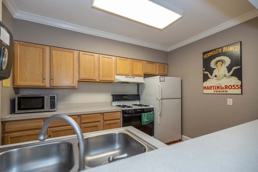 1500 Worcester Road, Unit 217 Framingham, MA 01702 - Photo 30 of 37 a kitchen with a refrigerator and a sink