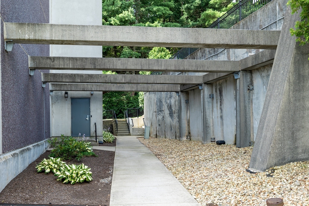 1500 Worcester Road, Unit 217 Framingham, MA 01702 - Photo 33 of 37 a front view of a house with a wooden fence