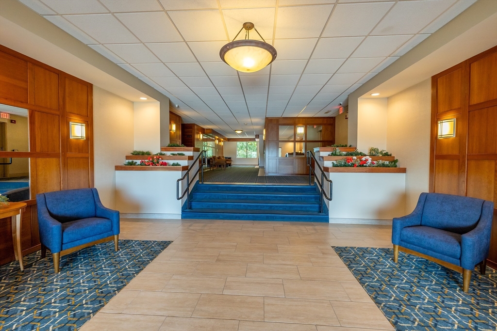 1500 Worcester Road, Unit 217 Framingham, MA 01702 - Photo 5 of 37 a living room with furniture and wooden floor