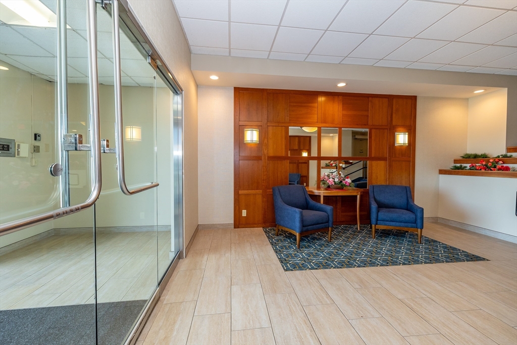 1500 Worcester Road, Unit 217 Framingham, MA 01702 - Photo 6 of 37 a lobby with furniture and wooden floor