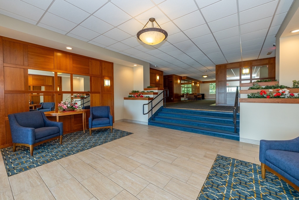 1500 Worcester Road, Unit 217 Framingham, MA 01702 - Photo 7 of 37 a lobby with furniture and a rug