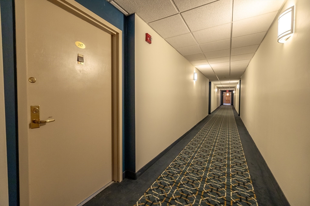 1500 Worcester Road, Unit 217 Framingham, MA 01702 - Photo 9 of 37 a view of hallway with wooden floor