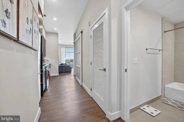 a view of a hallway with wooden floor and staircase