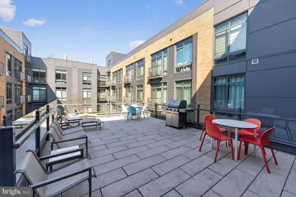 a building outdoor space with patio furniture and potted plants