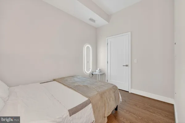 a bedroom with a bed and a dresser