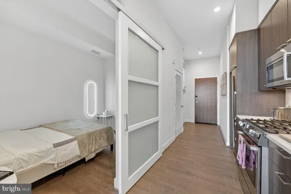 a bedroom with a bed and a kitchen sink