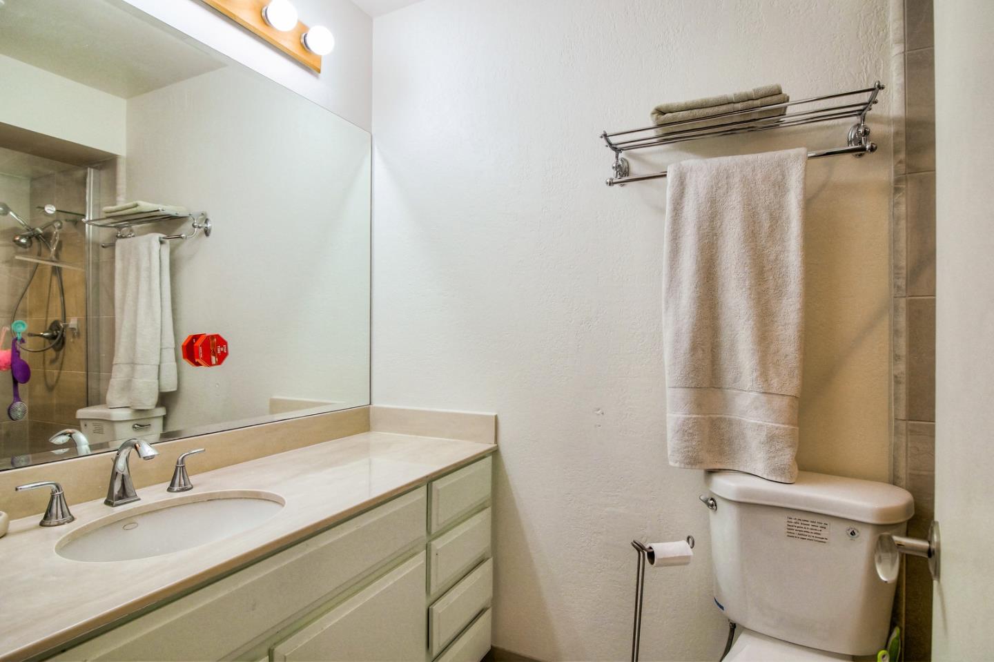 709 Timber Trail Pacific Grove, CA 93950 - Photo 17 of 19 a bathroom with a granite countertop sink toilet and shower