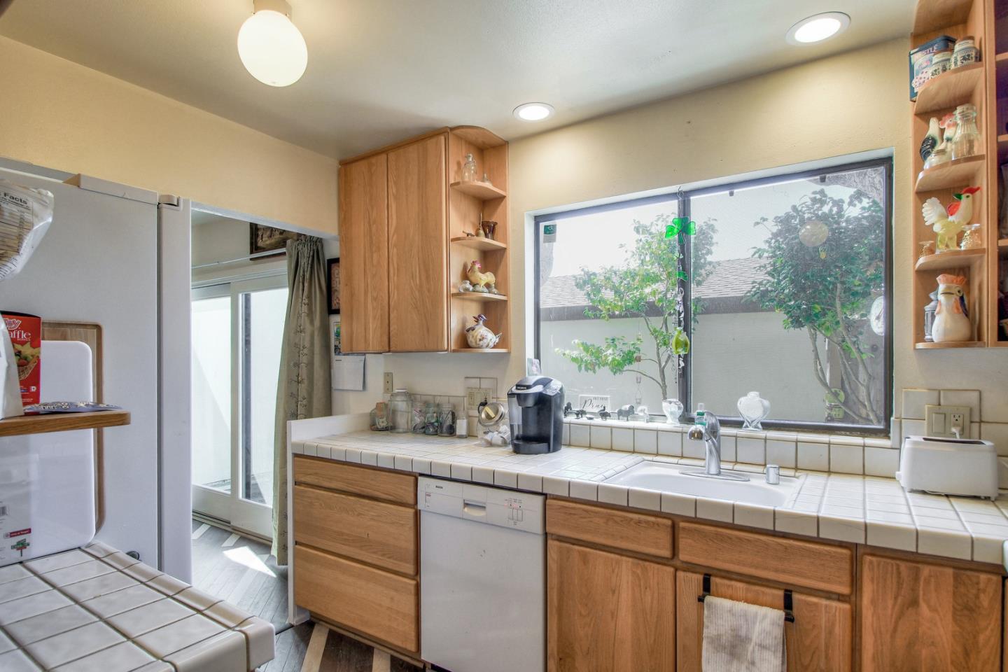 709 Timber Trail Pacific Grove, CA 93950 - Photo 8 of 19 a kitchen with stainless steel appliances granite countertop a sink and a refrigerator