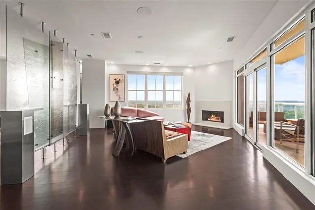 a kitchen with stainless steel appliances granite countertop a stove refrigerator and a view of living room