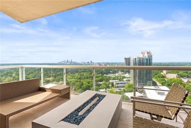 a dining room with furniture wooden floor and a large window