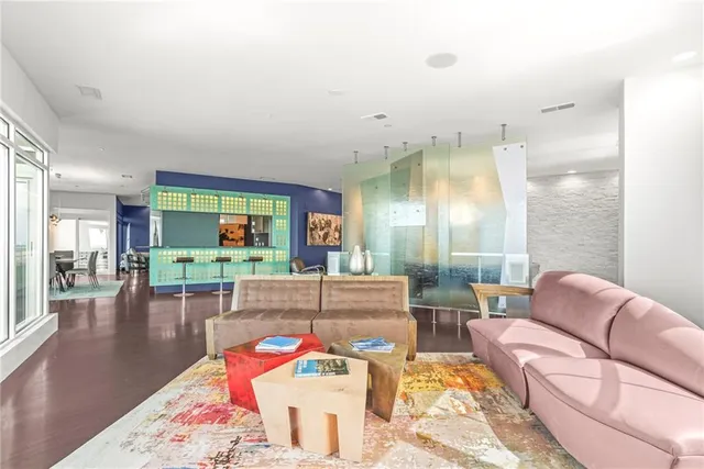 a living room with furniture and a floor to ceiling window