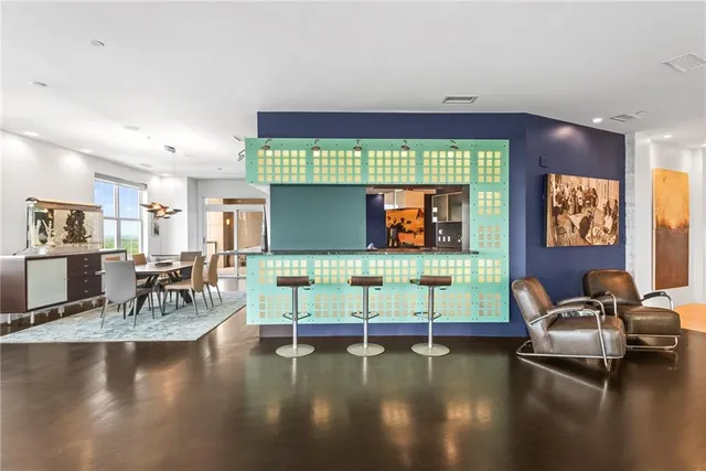 a living room with furniture and large windows