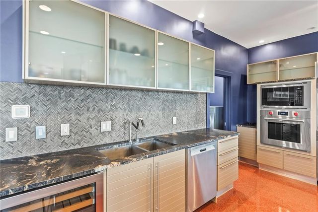 a living room with a fireplace and a floor to ceiling window
