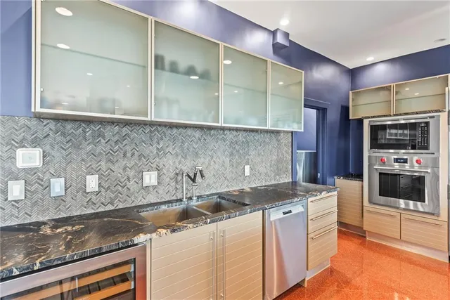 a living room with a fireplace and a floor to ceiling window