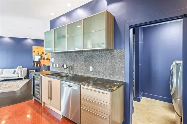 a bathroom with a granite countertop sink a mirror and a bathtub