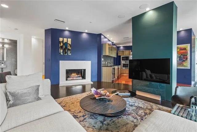 a spacious bedroom with a bed couch and a large window