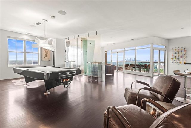 a living room with a large window and furniture