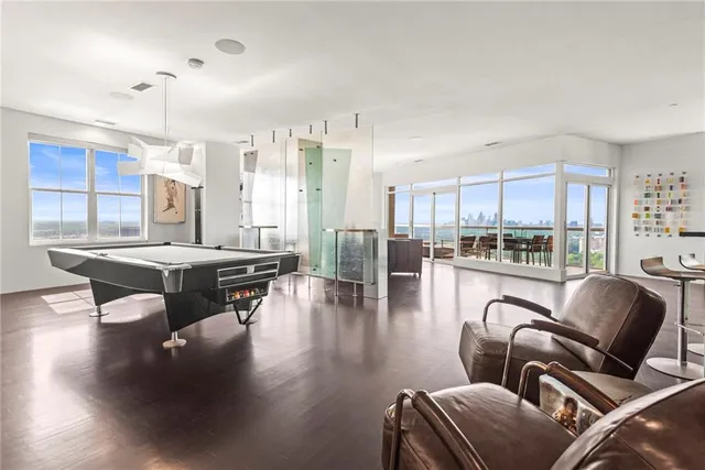 a living room with a large window and furniture