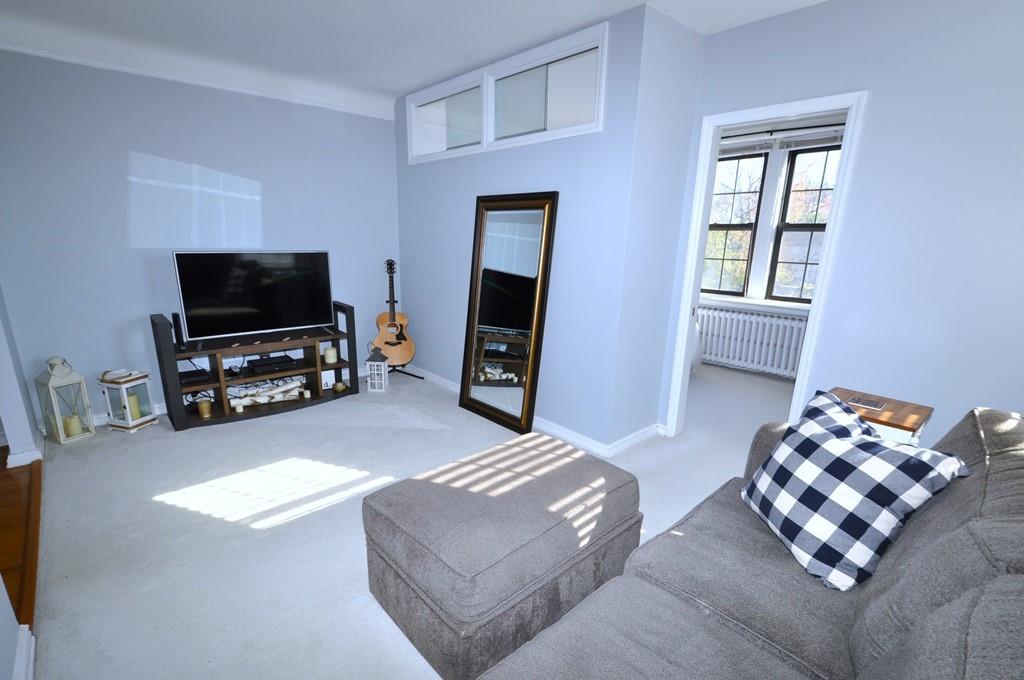 This spacious and sunny corner studio with eastern and southern exposures has been custom designed to include an extra room for sleeping off the living room, separated by a space-saving pocket door.