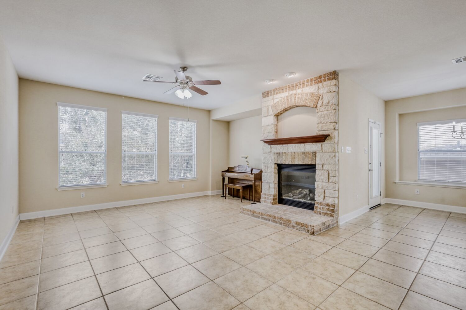 24 Stone Terrace Drive Austin, TX 78734 - Photo 11 of 32 an empty room with windows and fireplace