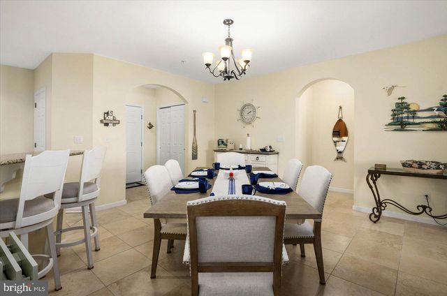 a kitchen with granite countertop a refrigerator and a stove top oven