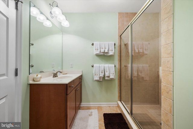 a large bed sitting in a bedroom next to a window