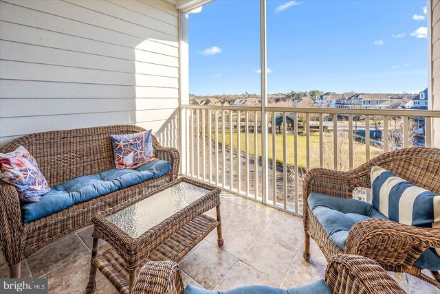 a view of a balcony with wooden floor and lake view