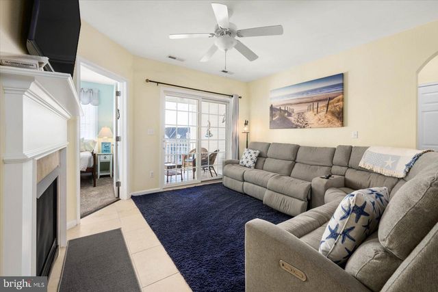 a living room with a fireplace a flat screen tv and a fireplace