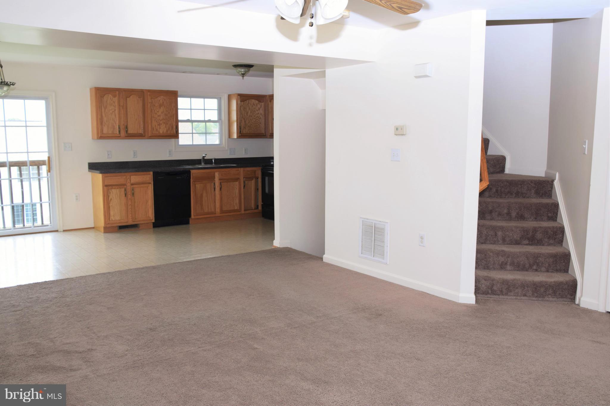25 Fuzzy Tail Drive Ranson, WV 25438 - Photo 11 of 25 an empty room with a window and a kitchen