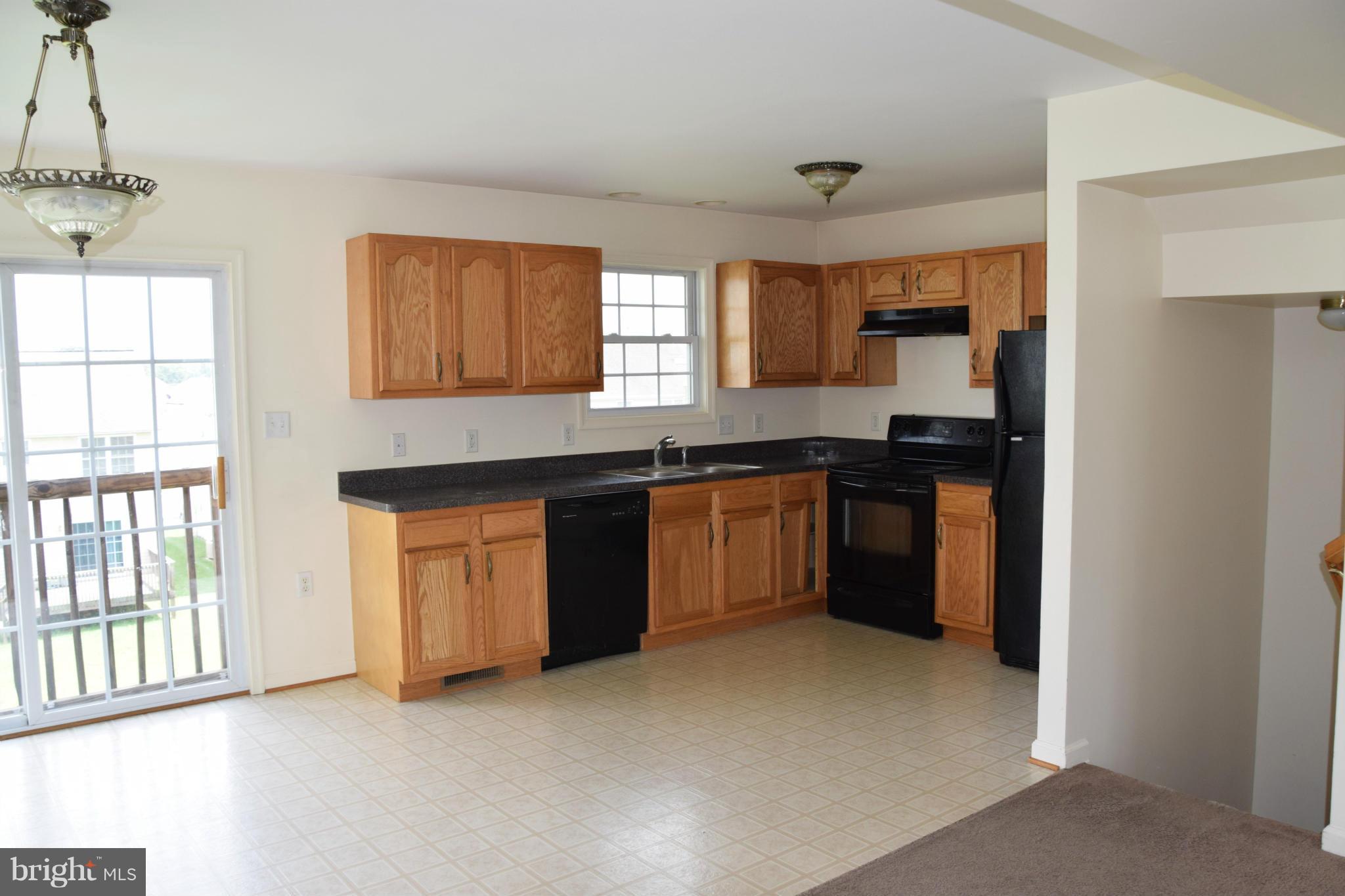 25 Fuzzy Tail Drive Ranson, WV 25438 - Photo 12 of 25 a kitchen with stainless steel appliances granite countertop a stove a sink dishwasher a refrigerator and a window