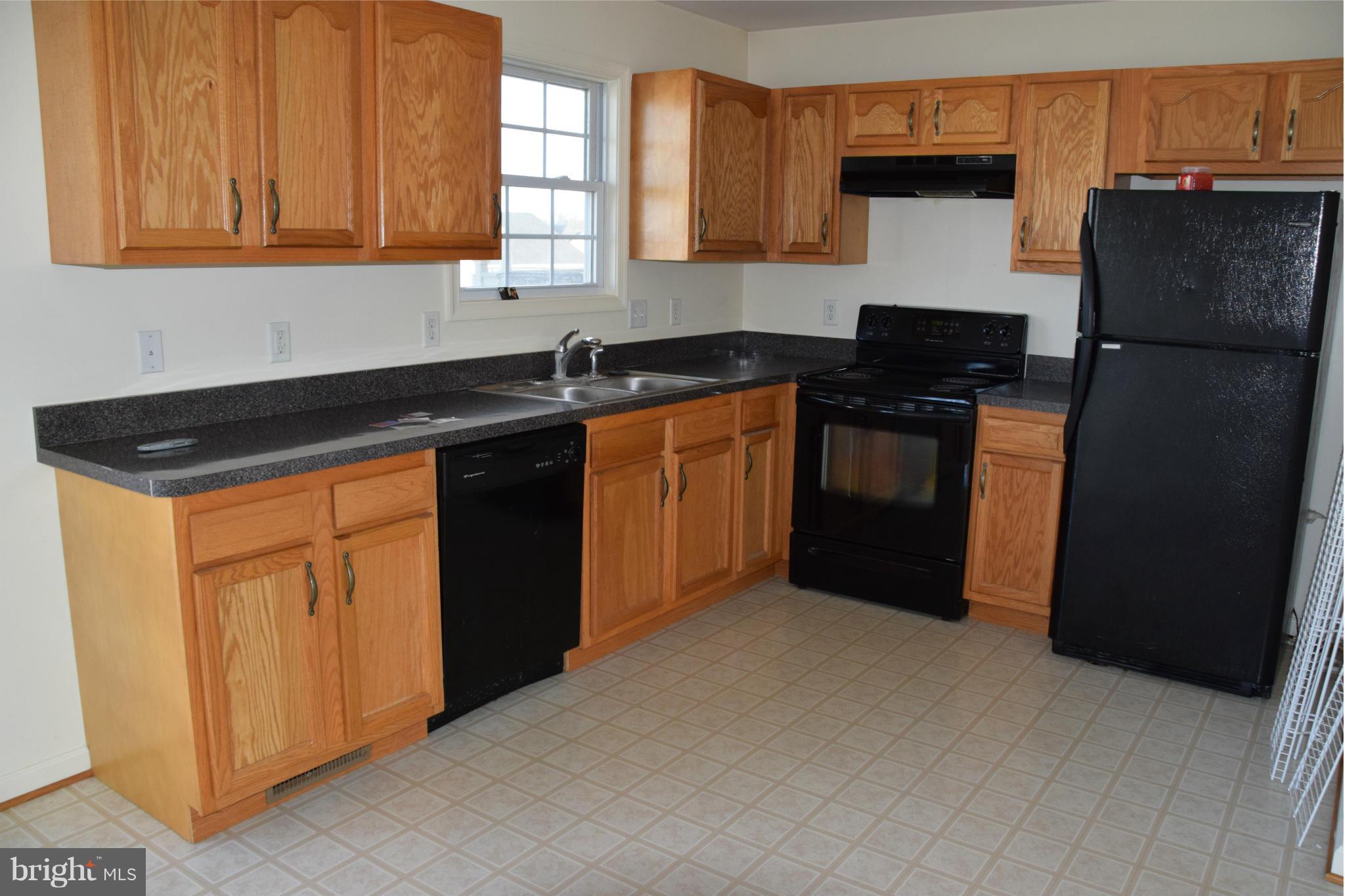 25 Fuzzy Tail Drive Ranson, WV 25438 - Photo 14 of 25 a kitchen with a refrigerator and a sink
